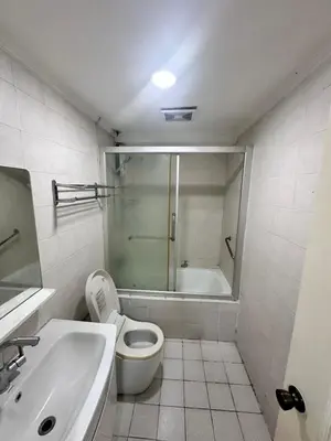 a bathroom with a shower and a toilet and a sink at Tranquil Harbor in Manila
