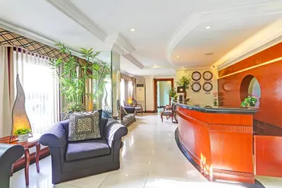 a living room with a bar and chairs at VIP Hostel, Near PNR Pasay Evangelista, Makati Manila in Manila