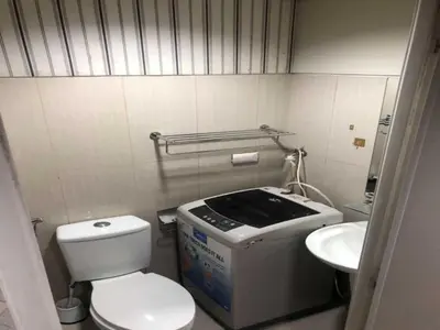 a small bathroom with a toilet and a sink at VIP Hostel, Near PNR Pasay Evangelista, Makati Manila in Manila