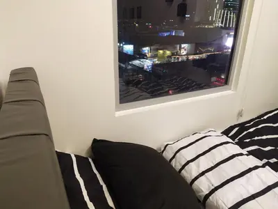 a couch sitting in a room with a window at MJ Luxe Stays in Manila