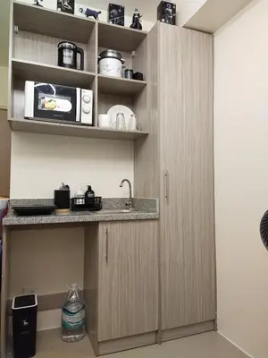 a kitchen with a sink and a microwave at MJ Luxe Stays in Manila
