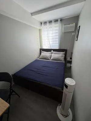 a small bedroom with a blue bed in a room at 2BR Apartment in Pasig City in Manila