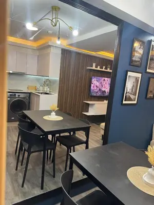 a kitchen and dining room with a table and chairs at 2BR Apartment in Pasig City in Manila