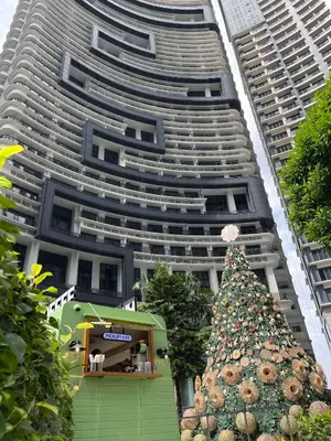 a christmas tree in front of a tall building at Condo in Makati in Manila