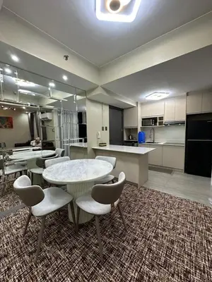 a large room with tables and chairs and a kitchen at La nobleza terrazas 2 bedroom condominium in Manila