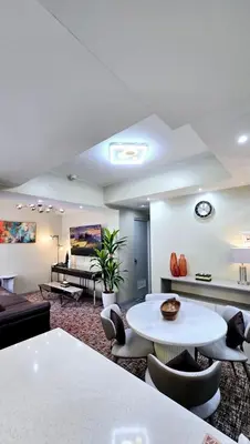 a large living room with a table and chairs at La nobleza terrazas 2 bedroom condominium in Manila