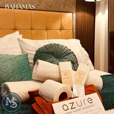 a pile of towels and toiletries on a bed at Azure Residences Bahamas good for 3 pax in Manila
