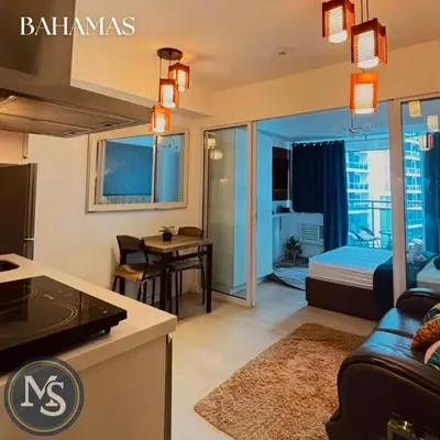 a living room with a couch and a bed in a room at Azure Residences Bahamas good for 3 pax in Manila