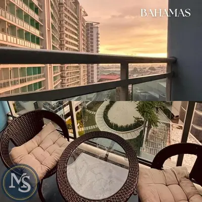a balcony with chairs and a table on a balcony at Azure Residences Bahamas good for 3 pax in Manila