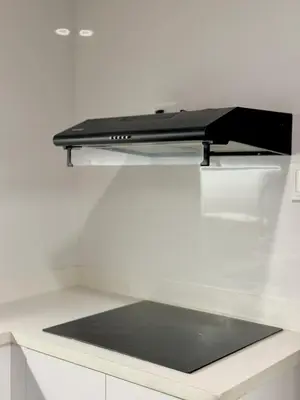 a black appliance sitting on top of a kitchen counter at Sea Residences 2BR Pool View Unit for 4-8 pax - Beehive Stay MOA in Manila