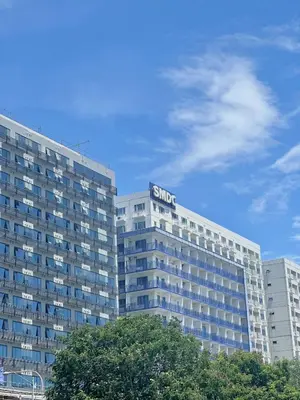 a building with a sign on the top of it at Sea Residences 2BR Pool View Unit for 4-8 pax - Beehive Stay MOA in Manila