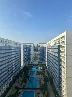an aerial view of a large building with a pool at Sea Residences 2BR Pool View Unit for 4-8 pax - Beehive Stay MOA in Manila