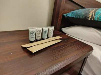 a table with three cups on top of a bed at Modern-Studio with Balcony Stunning View in Manila