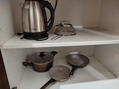 a tea kettle and pots on a shelf in a kitchen at Modern-Studio with Balcony Stunning View in Manila