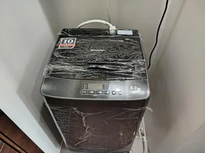 a toaster oven covered in plastic sitting next to a wall at Modern-Studio with Balcony Stunning View in Manila