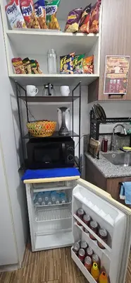 a kitchen with an open refrigerator with food at Laidback Cavern at Studio City Alabang in Manila
