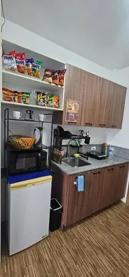 a kitchen with a sink and a counter top at Laidback Cavern at Studio City Alabang in Manila