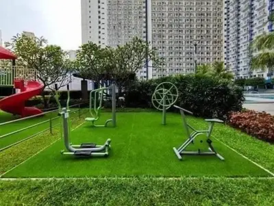a park with playground equipment on the grass at Family Suites- Self Service Condo Unit in Jazz Residences Makati in Manila