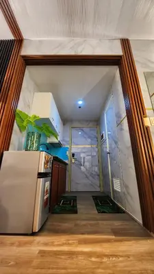 a small kitchen with a refrigerator in a room at Family Suites- Self Service Condo Unit in Jazz Residences Makati in Manila