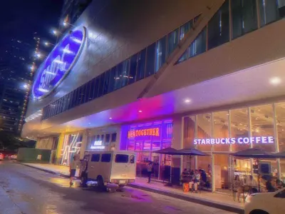 a store front of a building with a starbucks coffee at Family Suites- Self Service Condo Unit in Jazz Residences Makati in Manila