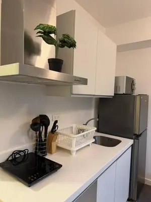 a kitchen with a sink and a counter top at A&J azure getaway in Manila