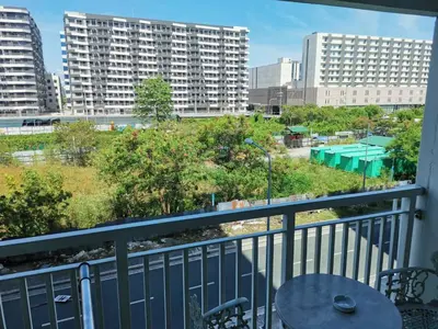 a balcony with a table and chairs and buildings at Sea Residences 2 BR by TVANS in Manila
