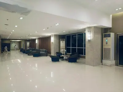 a lobby with couches and chairs in a building at Sea Residences 2 BR by TVANS in Manila