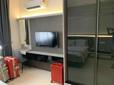 a hotel room with a bed and a television at Diamond Studio in Manila