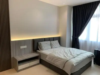a bedroom with a large bed with a window at Diamond Studio in Manila