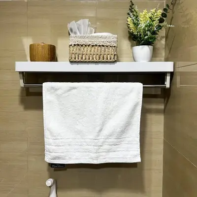 a towel hanging on a shelf in a bathroom at Crizzy's Hub Crizel at Shore Residences - 1BR with Balcony and Amenity view - Netflix and Disney - Near MOA in Manila