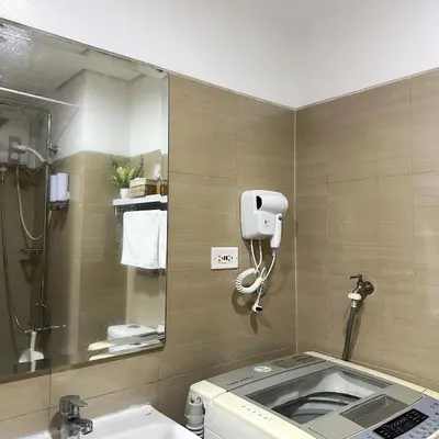 a bathroom with a shower and a toilet and a mirror at Crizzy's Hub Crizel at Shore Residences - 1BR with Balcony and Amenity view - Netflix and Disney - Near MOA in Manila