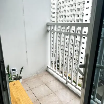 a balcony with a view of a tall building at Crizzy's Hub Crizel at Shore Residences - 1BR with Balcony and Amenity view - Netflix and Disney - Near MOA in Manila
