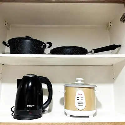 two pots and a tea kettle on a shelf at Crizzy's Hub Crizel at Shore Residences - 1BR with Balcony and Amenity view - Netflix and Disney - Near MOA in Manila