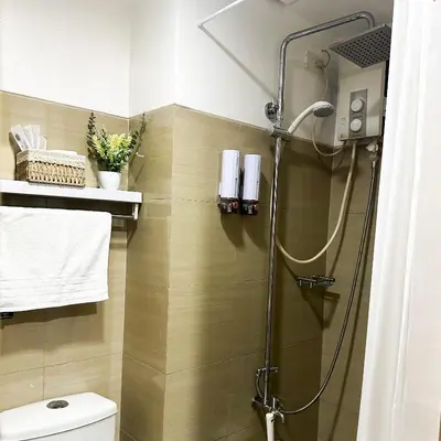 a bathroom with a shower and a toilet in it at Crizzy's Hub Crizel at Shore Residences - 1BR with Balcony and Amenity view - Netflix and Disney - Near MOA in Manila