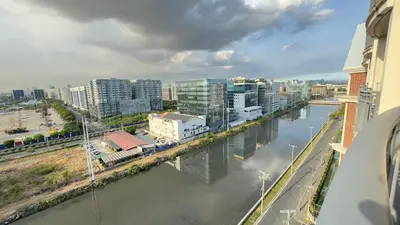 a view of a river in a city with buildings at Monarch Parksuites Balmoral Place Unit 1616 in Manila