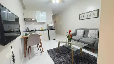 a living room with a couch and a table at Monarch Parksuites Balmoral Place Unit 1616 in Manila
