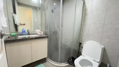 a bathroom with a shower and a toilet and a sink at Monarch Parksuites Balmoral Place Unit 1616 in Manila