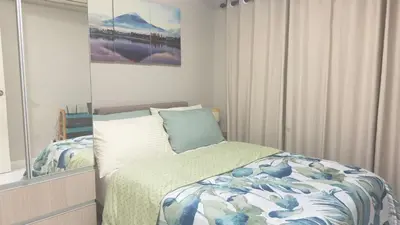 a bedroom with a bed and a mirror at Monarch Parksuites Balmoral Place Unit 1616 in Manila