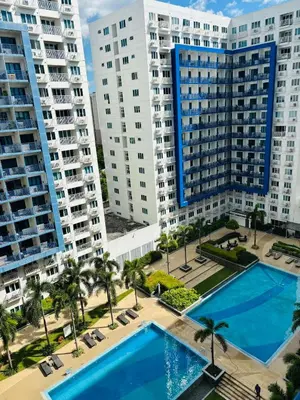 an aerial view of two large buildings and a pool at Sea Residence By Kenshin Staycation in Manila