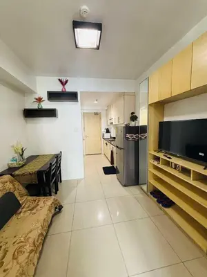a living room with a kitchen and a dining room at Sea Residence By Kenshin Staycation in Manila