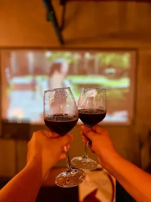 two people holding up glasses of red wine at Binangonan Primes Tiny Home with FREE breakfast and Plunge Pool in Binangonan