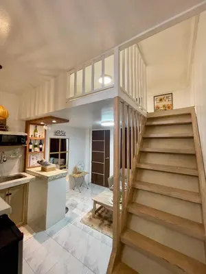 a staircase leading to a kitchen and a living room at Binangonan Primes Tiny Home with FREE breakfast and Plunge Pool in Binangonan
