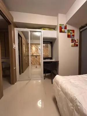 a bedroom with a bed and a desk and a window at S Residences, Tower-3 in Manila