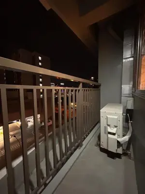 a room with a balcony with a fence and a train at S Residences, Tower-3 in Manila