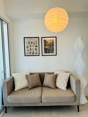 a couch sitting in a living room with a lamp at Cornelia Street at Azure Urban Resort Residences in Manila
