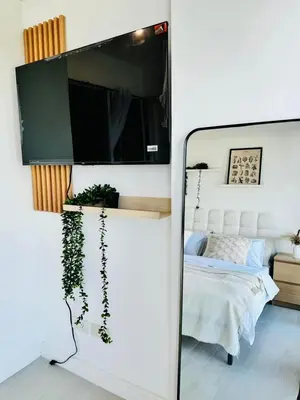 a mirror in a bedroom with a bed at Cornelia Street at Azure Urban Resort Residences in Manila