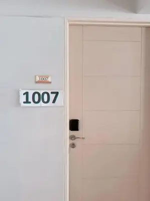 a door with a sign on it next to it at Tan condo fairway in Manila