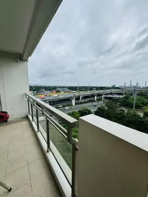 a balcony of a building with a view of a highway at Tan condo fairway in Manila