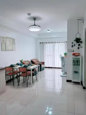 a kitchen and living room with a table and chairs at Tan condo fairway in Manila