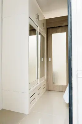 a dressing room with white cabinets and windows at Premium family Suite near MOA in Manila